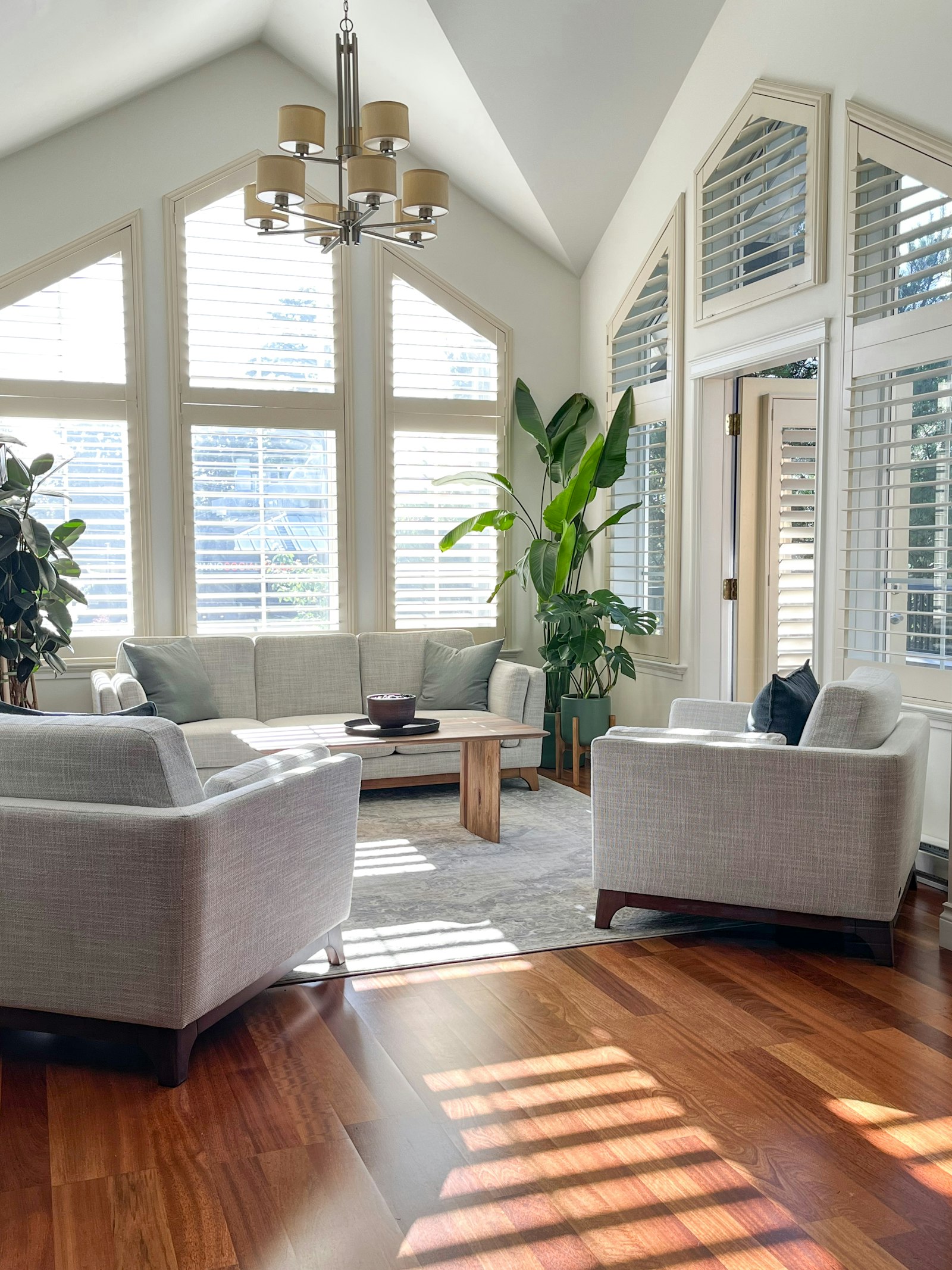 A bright living room with spotlessly clean windows letting the sunlight in